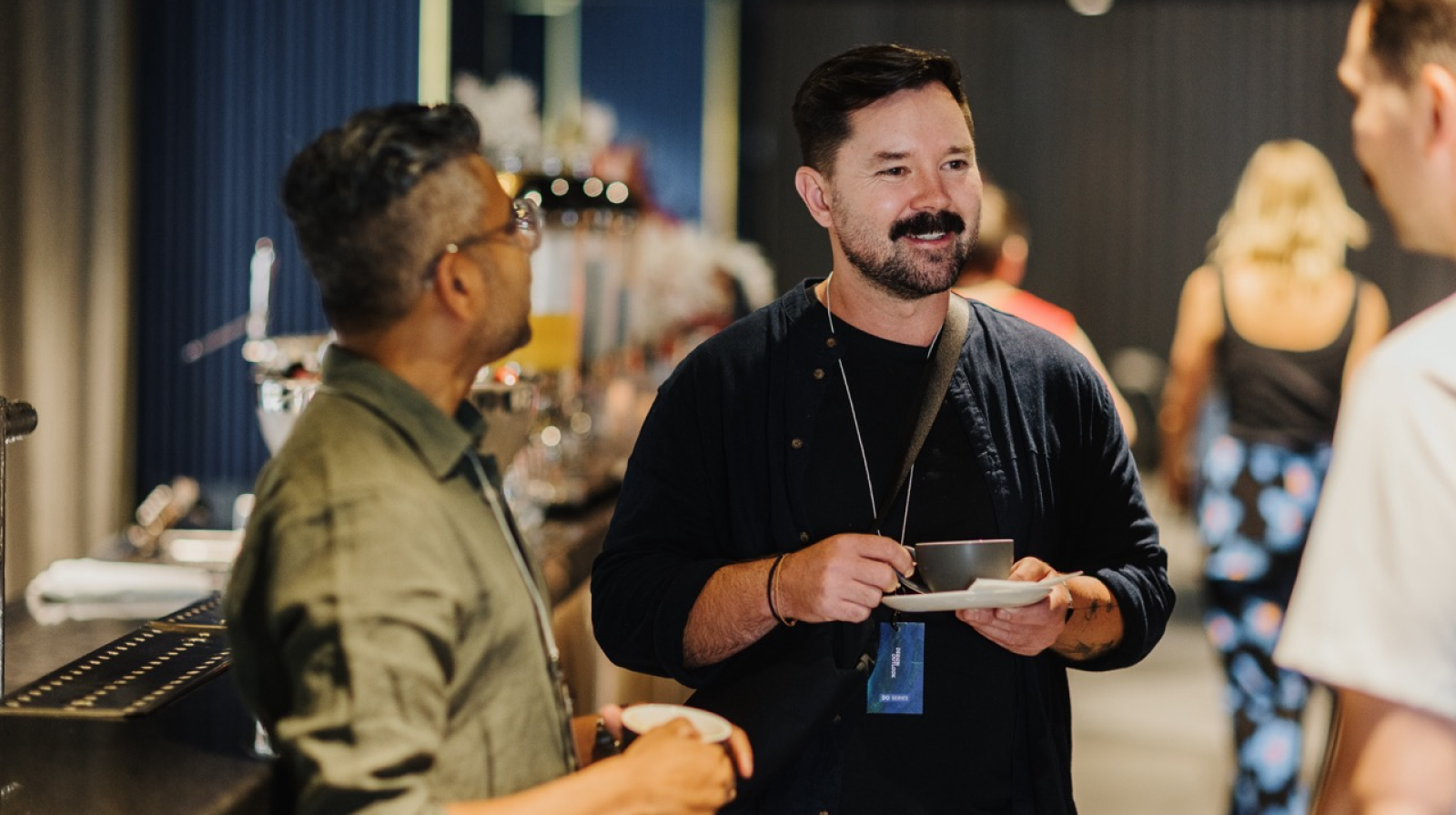 A photograph of attendees of Design Outlook having a break